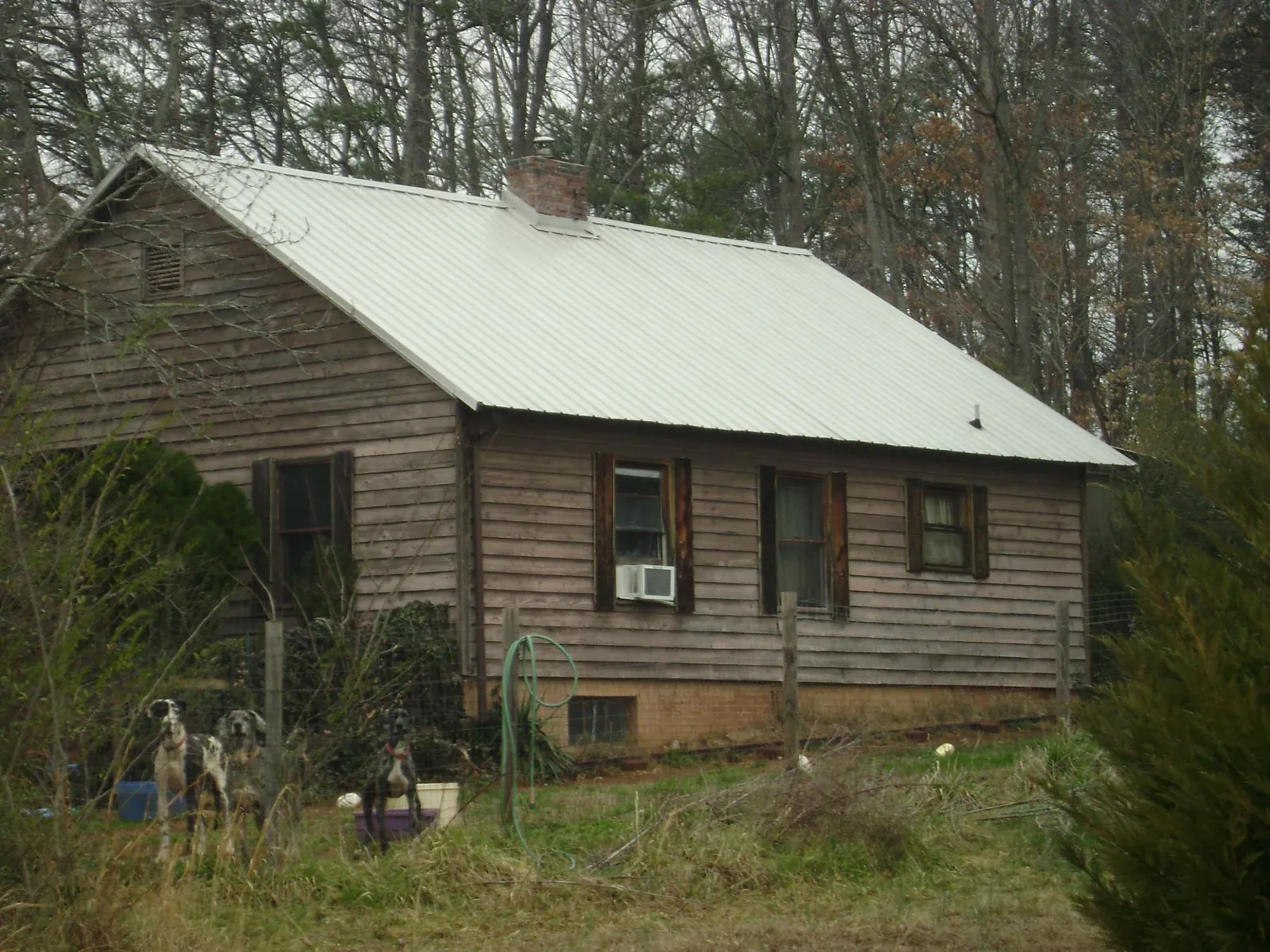 White metal roof on an old wood sided farmhouse, from a Metal Roof Installation job in Gill